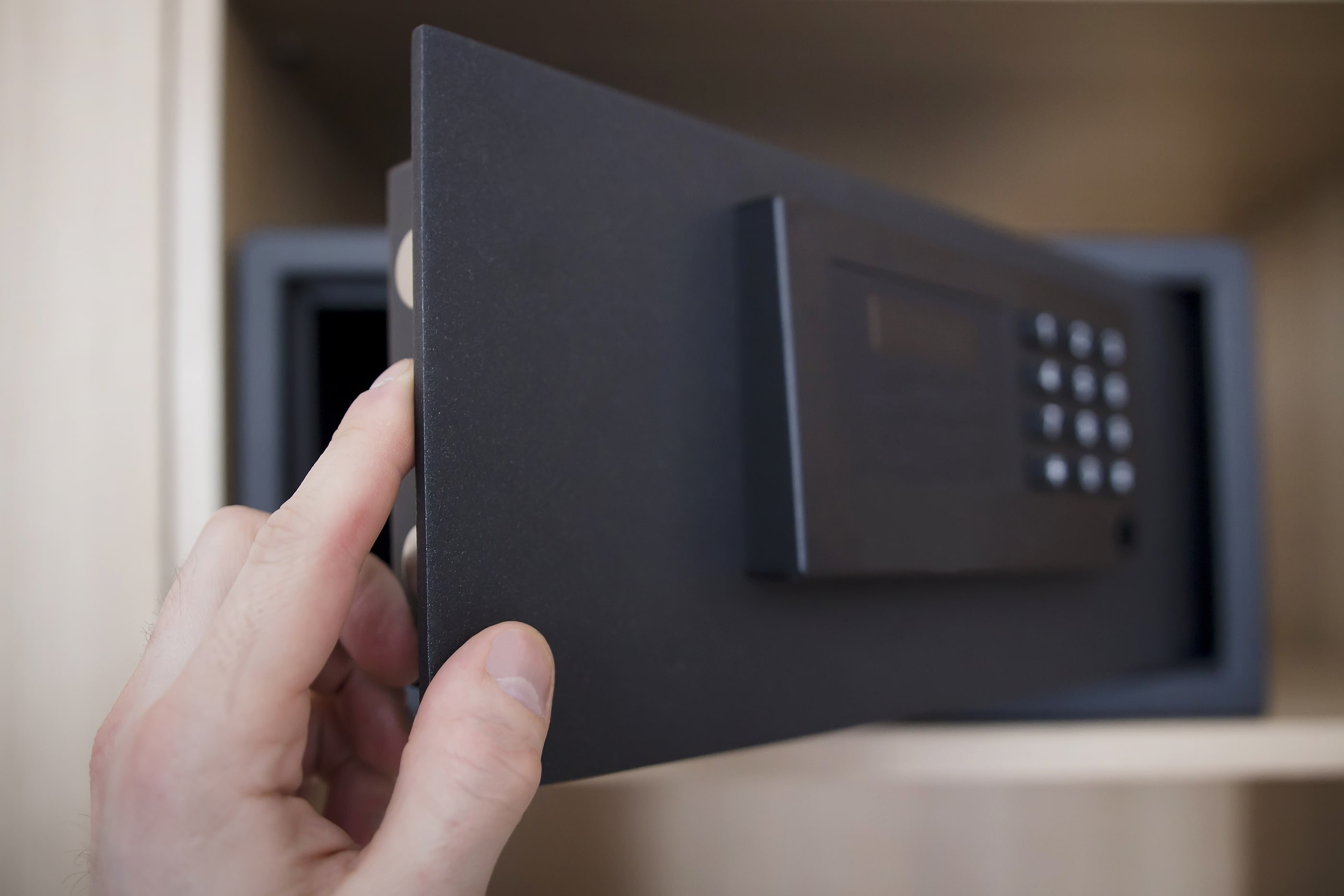Person opening the door of a safe